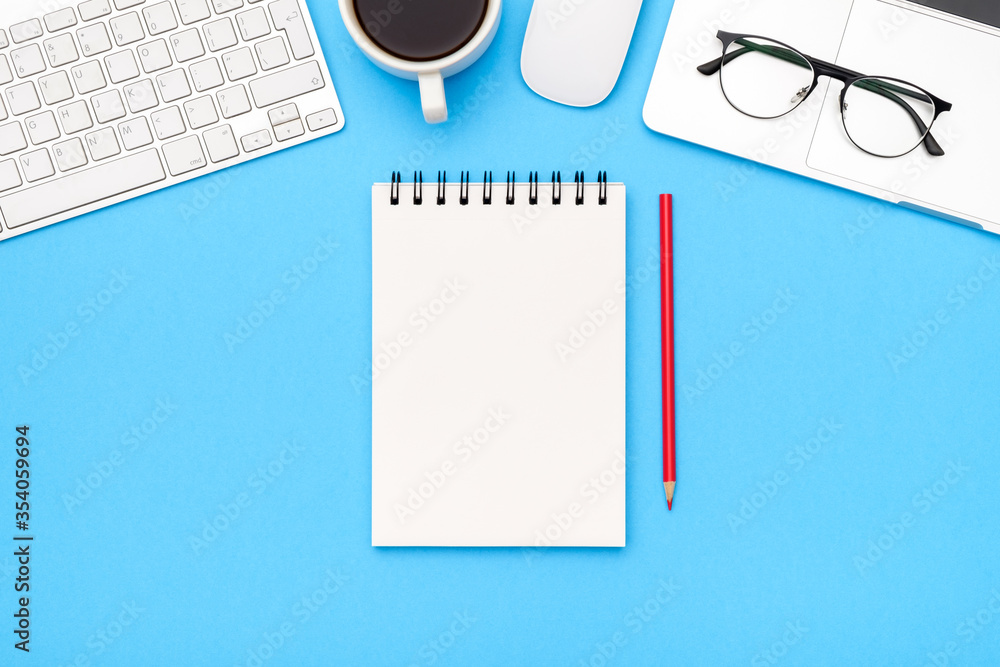 Minimal workplace with laptop and blank notepad Minimal workplace with laptop and blank notepad