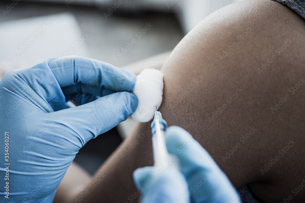 Vaccination of patients, Doctor provided a vaccine with a syringe against a new strain of virus or influenza in a modern hospital, Prevention and health care concept. Vaccination of patients, Doctor provided a vaccine with a syringe against a new strain of virus or influenza in a modern hospital, Prevention and health care concept.