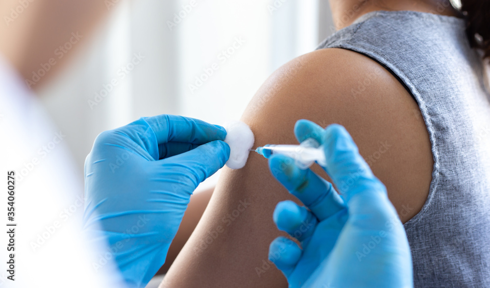 Vaccination of patients, Doctor provided a vaccine with a syringe against a new strain of virus or influenza in a modern hospital, Prevention and health care concept. Vaccination of patients, Doctor provided a vaccine with a syringe against a new strain of virus or influenza in a modern hospital, Prevention and health care concept.