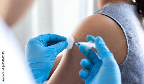Vaccination of patients  Doctor provided a vaccine with a syringe against a new strain of  virus or influenza in a modern hospital  Prevention and health care concept.