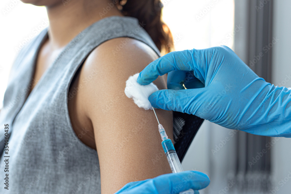 Vaccination of patients, Doctor provided a vaccine with a syringe against a new strain of virus or influenza in a modern hospital, Prevention and health care concept. Vaccination of patients, Doctor provided a vaccine with a syringe against a new strain of virus or influenza in a modern hospital, Prevention and health care concept.