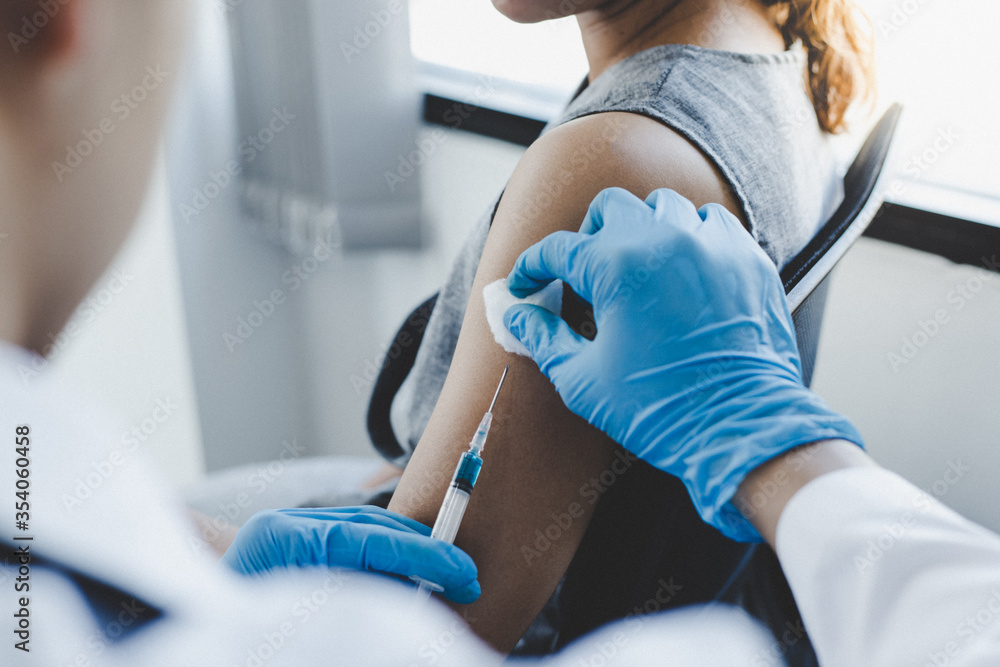 Vaccination of patients, Doctor provided a vaccine with a syringe against a new strain of virus or influenza in a modern hospital, Prevention and health care concept. Vaccination of patients, Doctor provided a vaccine with a syringe against a new strain of virus or influenza in a modern hospital, Prevention and health care concept.