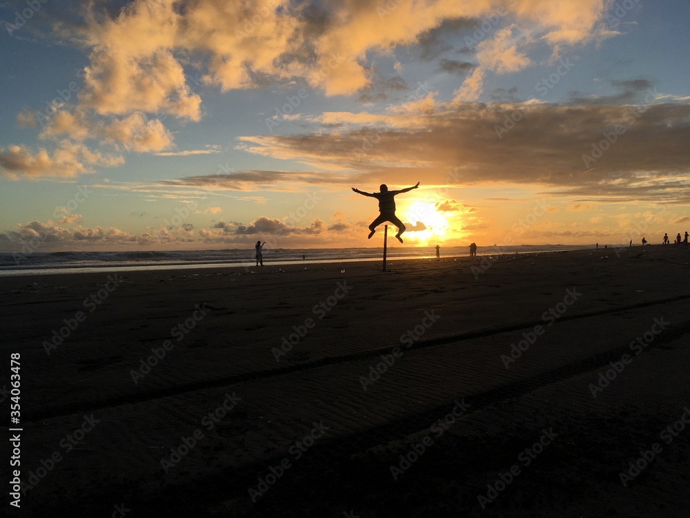 Golden Sunset in a tropical beach With sand, Horse and rock Golden Sunset in a tropical beach With sand, Horse and rock
