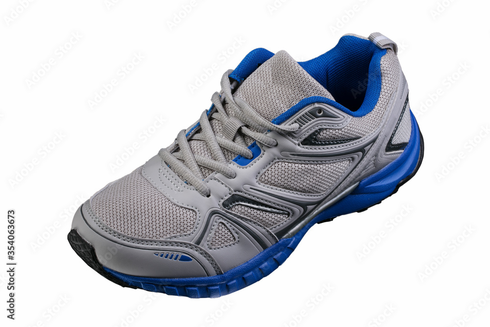 White sneaker with black accents isolated. Sports shoes on a white background. White sneaker with black accents isolated. Sports shoes on a white background.