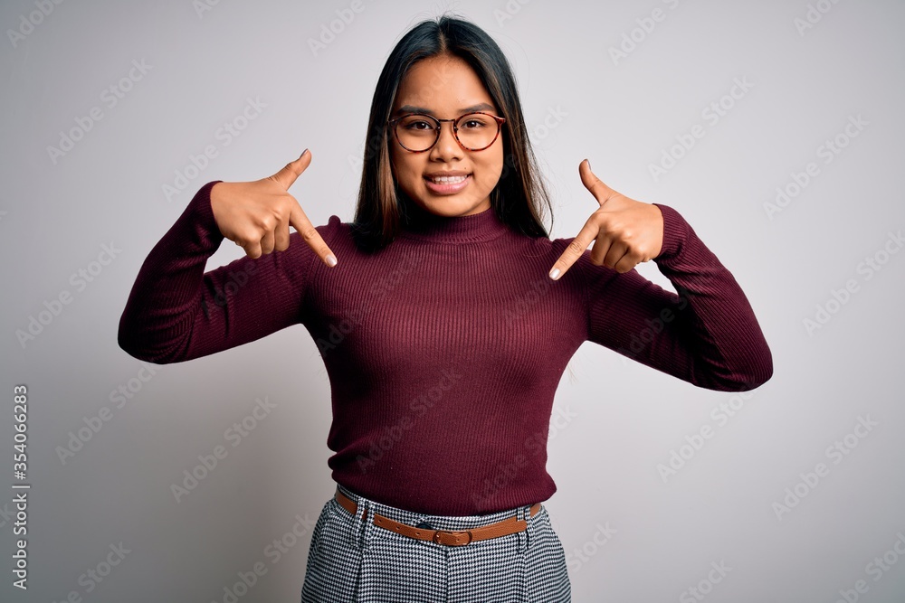 Beautiful asian business woman wearing casual sweater and glasses over white background looking confident with smile on face, pointing oneself with fingers proud and happy. Beautiful asian business woman wearing casual sweater and glasses over white background looking confident with smile on face, pointing oneself with fingers proud and happy.