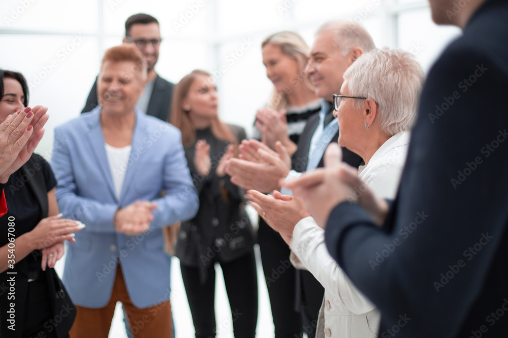 Successful business team smiling and applaudung Successful business team smiling and applaudung