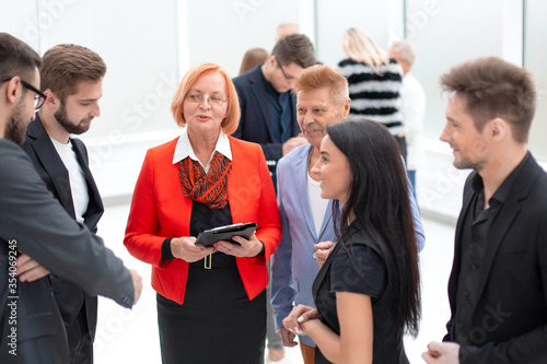 Business woman with team discussing the financial repor photo