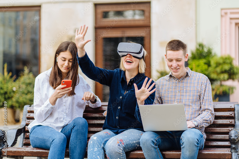 A young female freelancer works from home remotely using a laptop. Women children do her hair and interfere with work A young female freelancer works from home remotely using a laptop. Women children do her hair and interfere with work