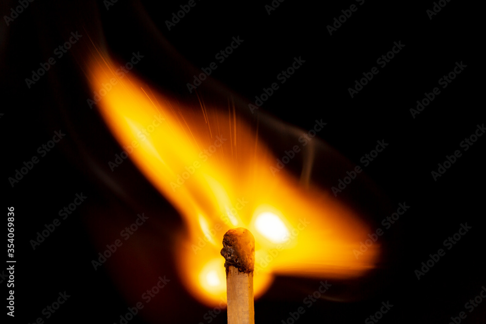 Burning match isolated on black background. Macro. Close up. Fire.