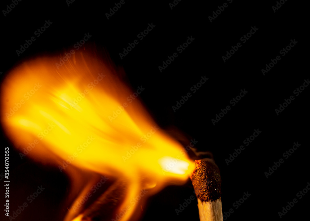 Burning match isolated on black background. Macro. Close up. Fire.
