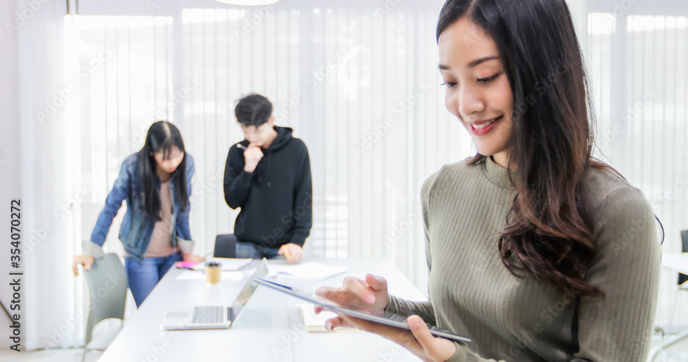 Asian female students use digital tablets to find information for work and study online. Asian female students use digital tablets to find information for work and study online.