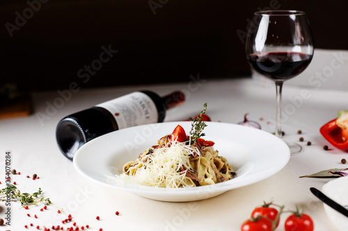 Italian pasta and wine and ingredients cherry tomatoes