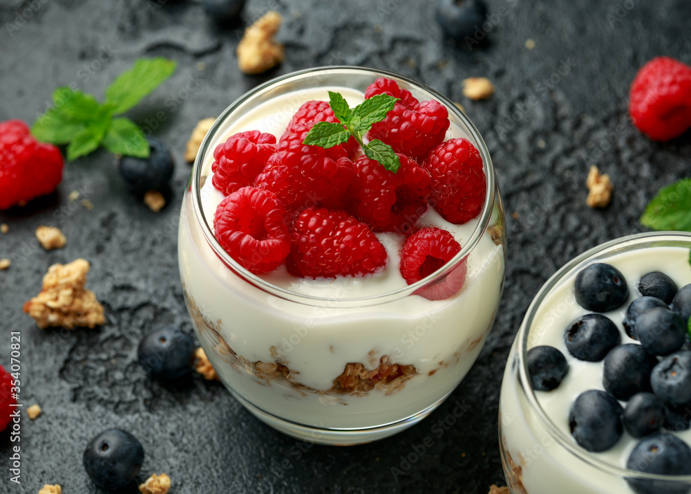 Greek yogurt with granola, raspberry, blueberry in glass jar. Healthy breakfast food or snack Greek yogurt with granola, raspberry, blueberry in glass jar. Healthy breakfast food or snack