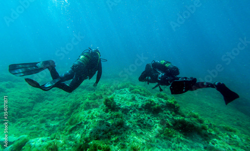 Scuba divers  diving in the mediterranean sea.