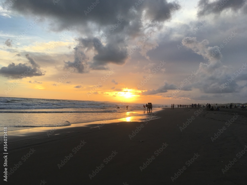 Golden Sunset in a tropical beach With sand, Horse and rock