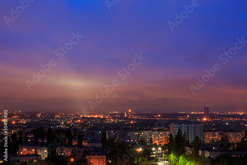 A night city in eastern Europe. On the outskirts of the city, an ore mine © MaksimM