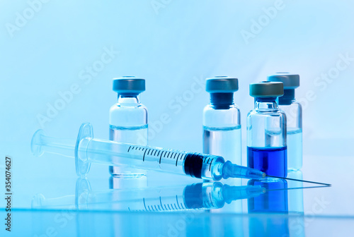 Close-up medical syringe with a vaccine. Vaccination and healtcare concept.