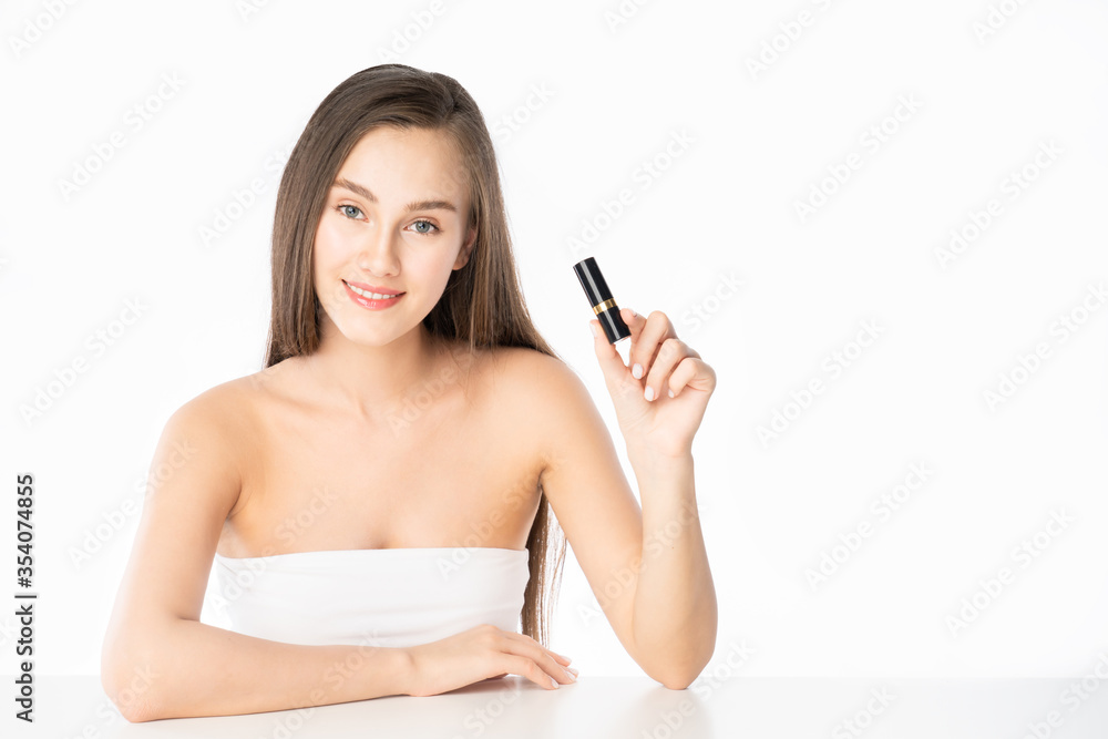 Beautiful young woman show mouth lipstick product in isolated white. Beautiful young woman show mouth lipstick product in isolated white.