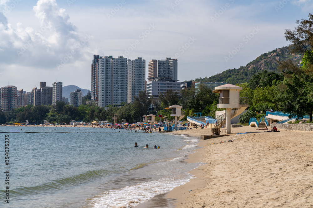 Hong Kong, China - May 16 2020: Golden Beach and Cafeteria Beach at Hong Kong Gold Beach. It is a private housing estate served by Castle Peak Road. Hong Kong, China - May 16 2020: Golden Beach and Cafeteria Beach at Hong Kong Gold Beach. It is a private housing estate served by Castle Peak Road.