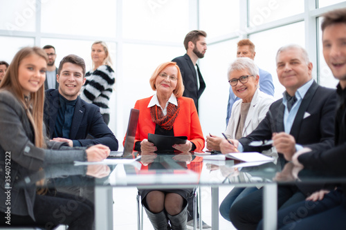 Business people during a meeting sitting around a glass table