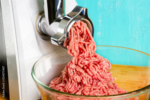 Close-up of cooking minced meat from the meat leaving the grinder. Electric meat grinder.