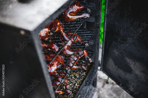 Fresh smoked chicken meat in smokehouse photo