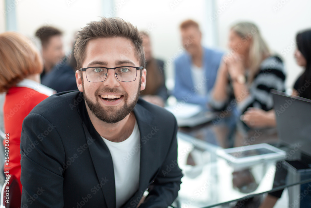 Handsome smiling business man wearing eyeglasses sitting in the Handsome smiling business man wearing eyeglasses sitting in the