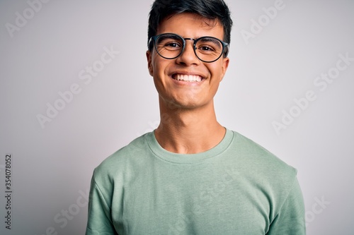 Young handsome man wearing casual t-shirt and glasses over isolated white background with a happy and cool smile on face. Lucky person. © Krakenimages.com