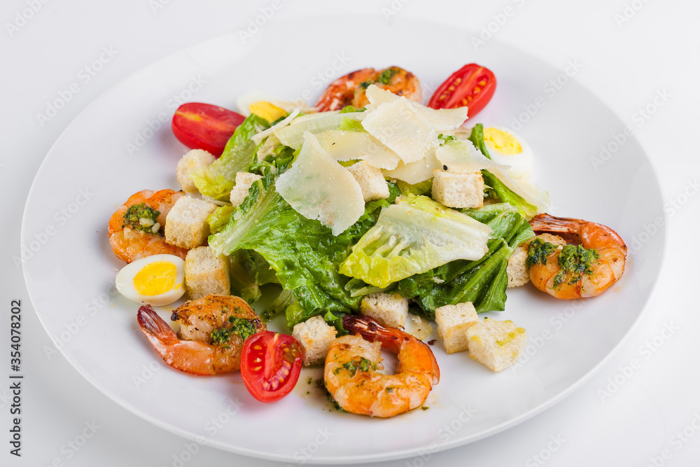 Caesar salad with prawns and parmesan cheese, croutons, tomatoes Caesar salad with prawns and parmesan cheese, croutons, tomatoes