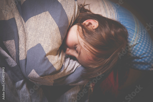 Top view of llittle beautiful young girl sleeping in bed. Health, holiday, happy childhood concept. photo