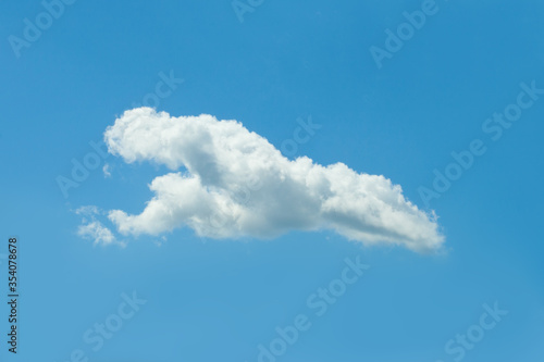 Blue sky background with one white cloud. © artmim