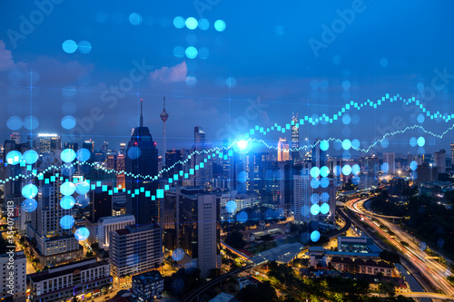 Photography FOREX graph hologram, aerial night panoramic cityscape of Kuala Lumpur
