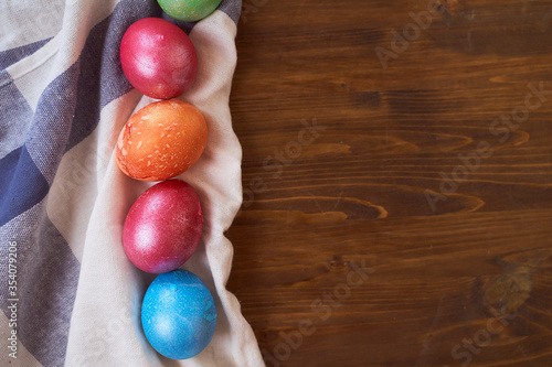 painted Easter eggs lying on wood background
