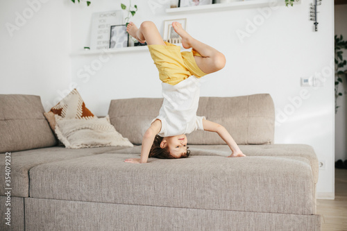 Fotografie Beautiful little toddler tumbling in grass