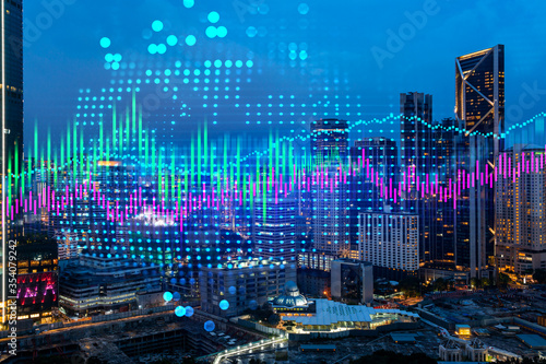 Photography Stock market graph hologram, night panorama city view of Kuala Lumpur