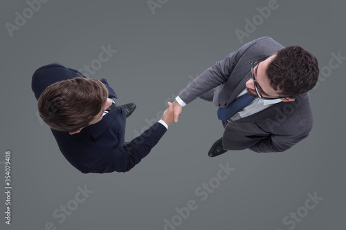 top view. business people shaking hands. isolated on white