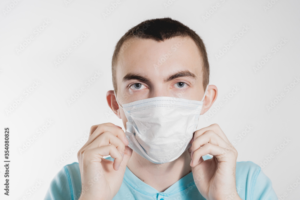 a man in a medical mask from kovid19 blue on a white background a man in a medical mask from kovid19 blue on a white background