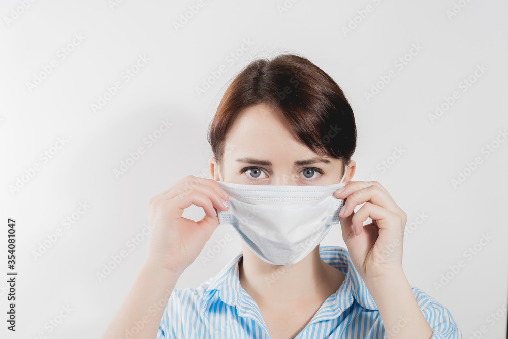 girl in a medical mask from kovid19 blue on a white background