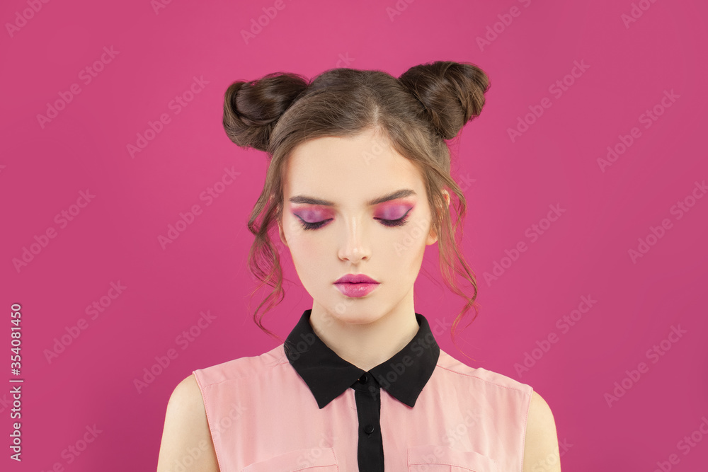 Fashion model woman with pink eyeshadow makeup on pink background Fashion model woman with pink eyeshadow makeup on pink background