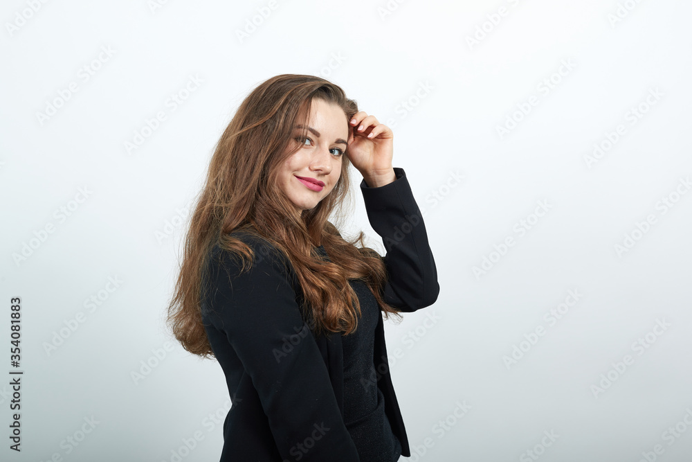 Young Attractive Woman Brunette In In A Black T-Shirt, Sweater On White Background, Cute Female Touches Her Hair And Body. People's Tenderness, Kindness Young Attractive Woman Brunette In In A Black T-Shirt, Sweater On White Background, Cute Female Touches Her Hair And Body. People's Tenderness, Kindness