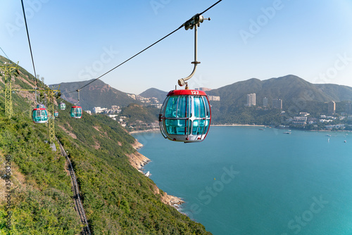The sunny view of cable car and theme park near to ocean