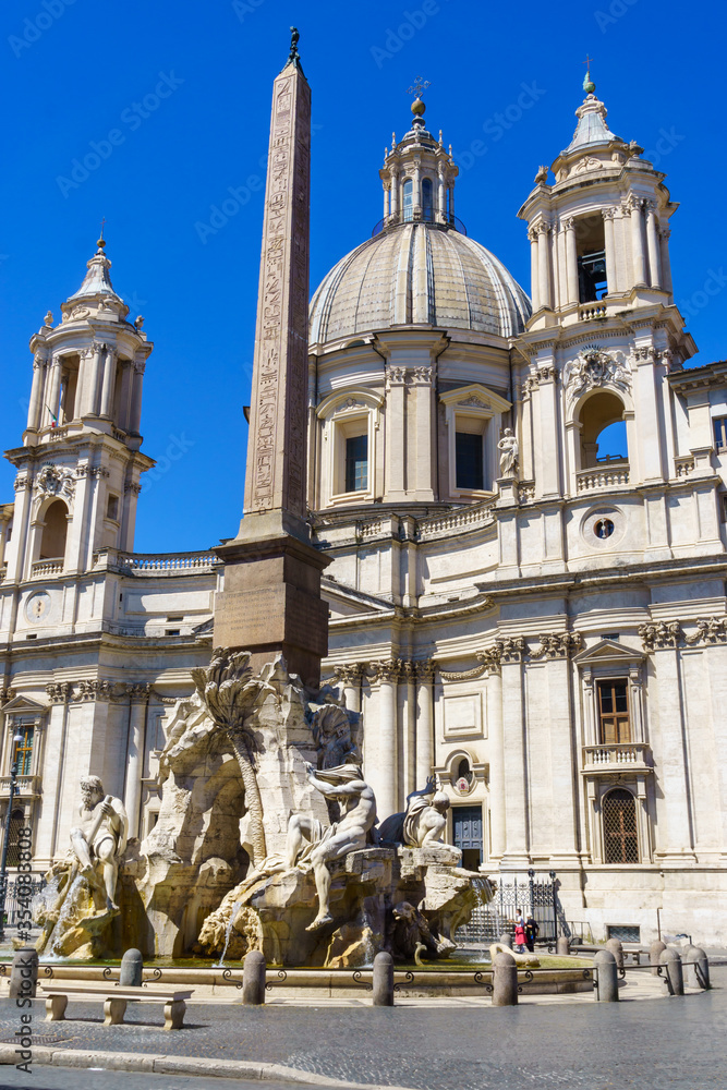 Fountain of the Four Rivers with an Egyptian obelisk and Sant Agnese Church on the famous Piazza Navona Square in the morning, Rome, Italy