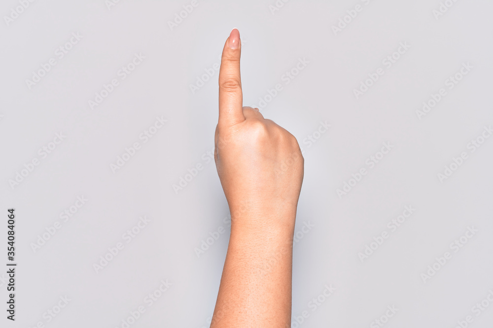 Hand of caucasian young woman counting number one using index finger, showing idea and understanding Hand of caucasian young woman counting number one using index finger, showing idea and understanding