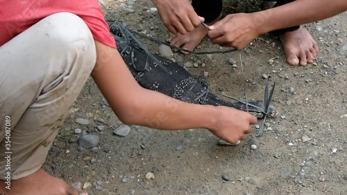 people catch and tie monitor lizard photo