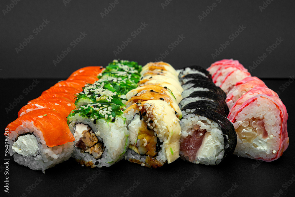 Large set of Delicious sushi rolls. A lot assortment Philadelphia roll Dishes from Japanese raw fish. Japan food menu service Large set of Delicious sushi rolls. A lot assortment Philadelphia roll Dishes from Japanese raw fish. Japan food menu service