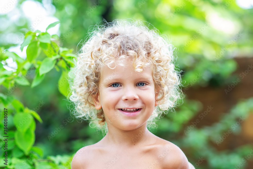 Portrait of a curly white boy in the park Portrait of a curly white boy in the park
