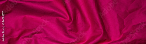 crinkled red material texture or background. photo