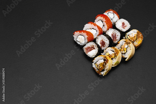 traditional japanese sushi set serviced on black background. tasty set of sushi, nigiri, sashimi and maki.