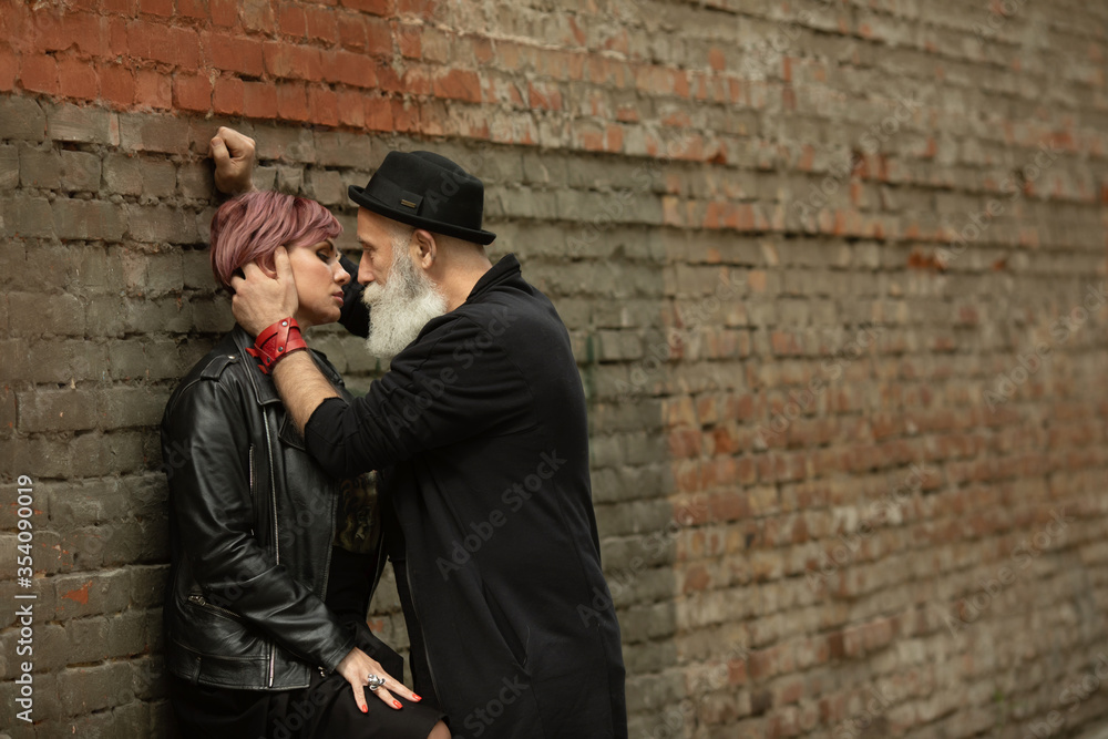 Bearded Senior man and woman wearing leather jackets. Happy couple of retirees in biker clothes. Bearded Senior man and woman wearing leather jackets. Happy couple of retirees in biker clothes.