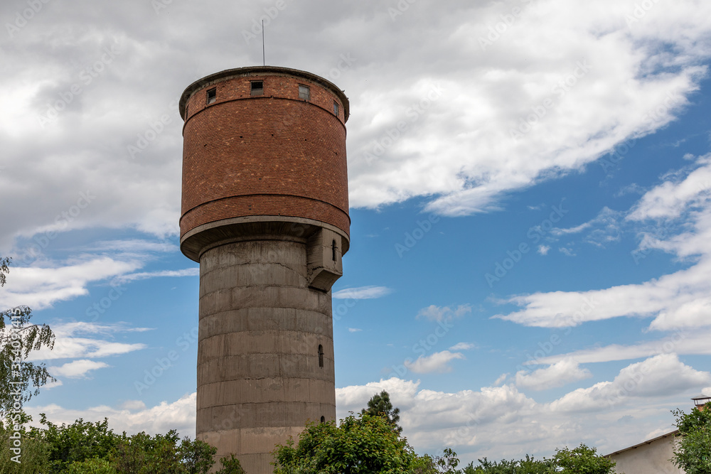 Abandoned brick and concrete water tower.